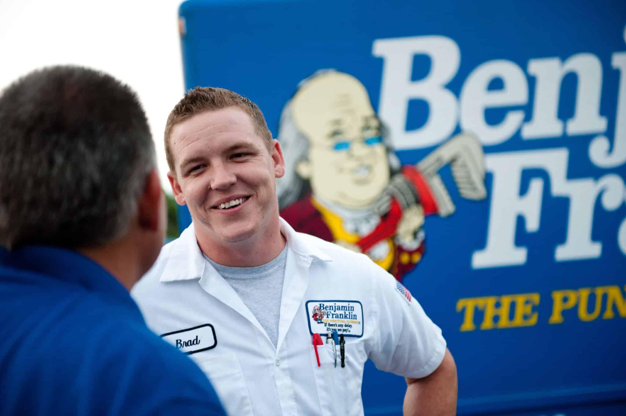 Benjamin Franklin Plumbing tech talking with homeowner