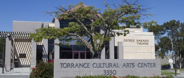A building with a sign and a tree