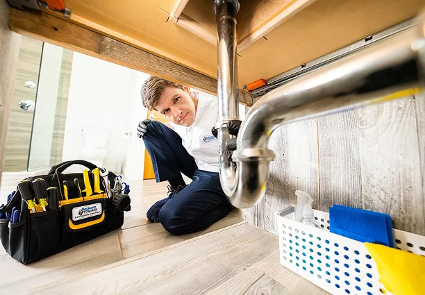 A professional working on drain repair