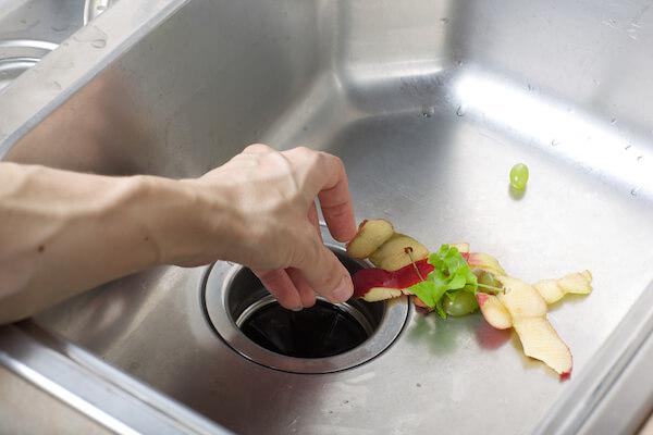 Food going down a garbage disposal.