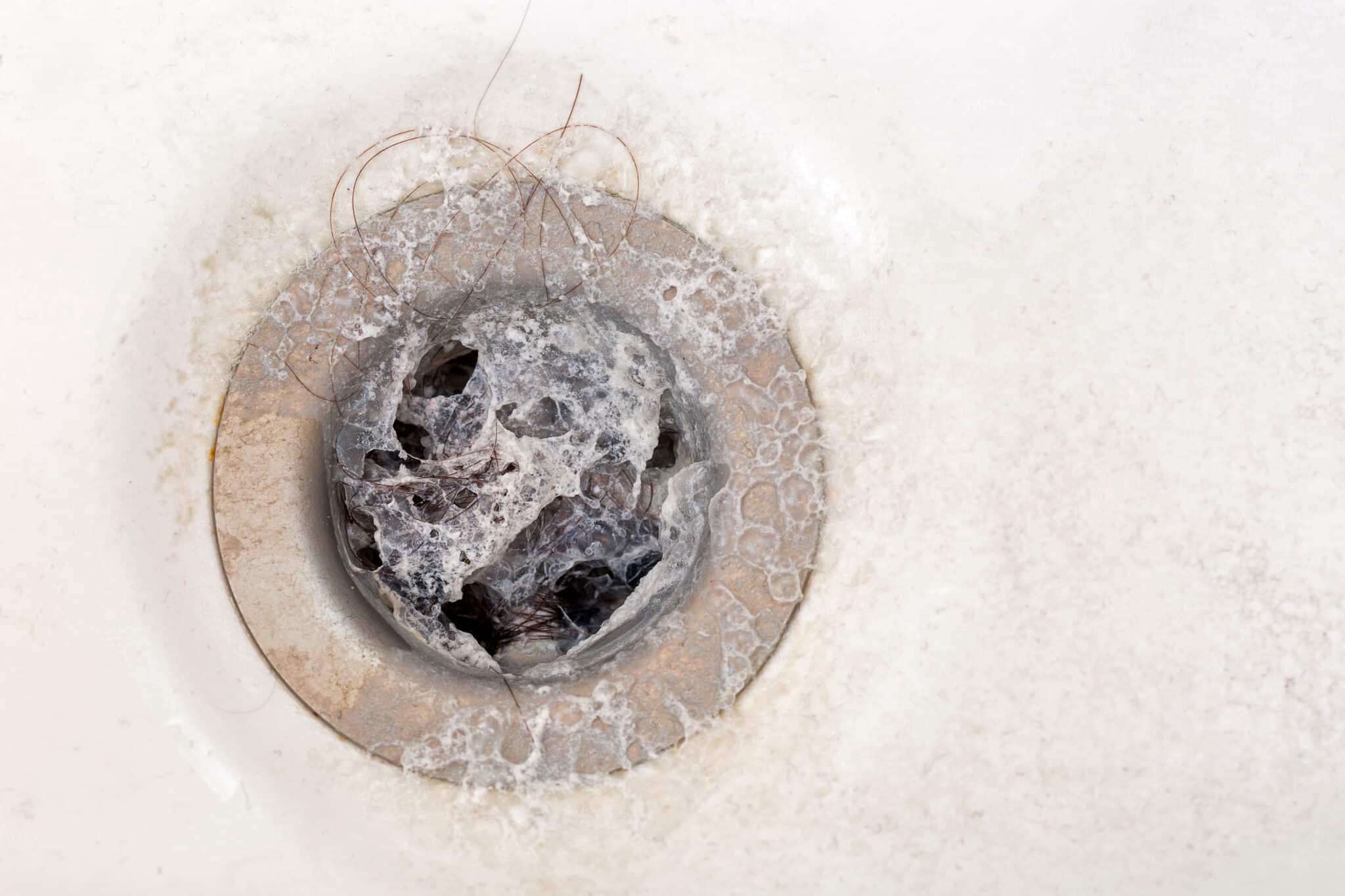 clogged bathtub drain with hair