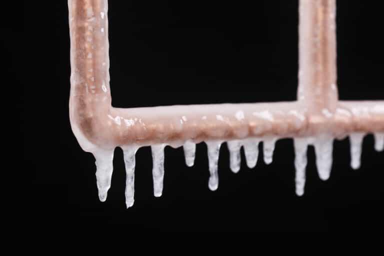 Icicles Forming on a Frozen Copper Pipe