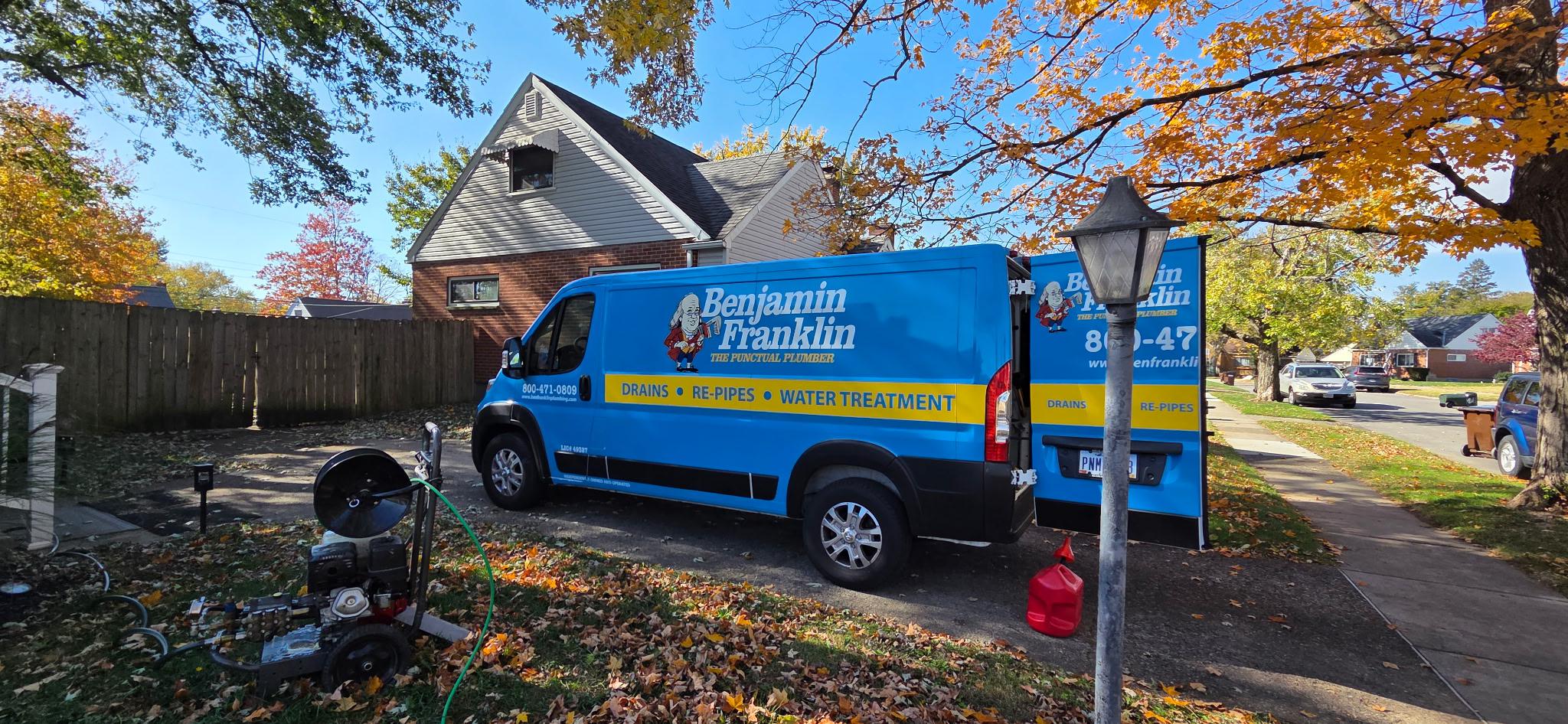 A blue Benjamin Franklin Plumbing van