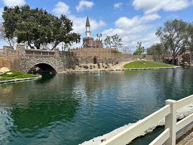 A body of water with a bridge and a stone wall