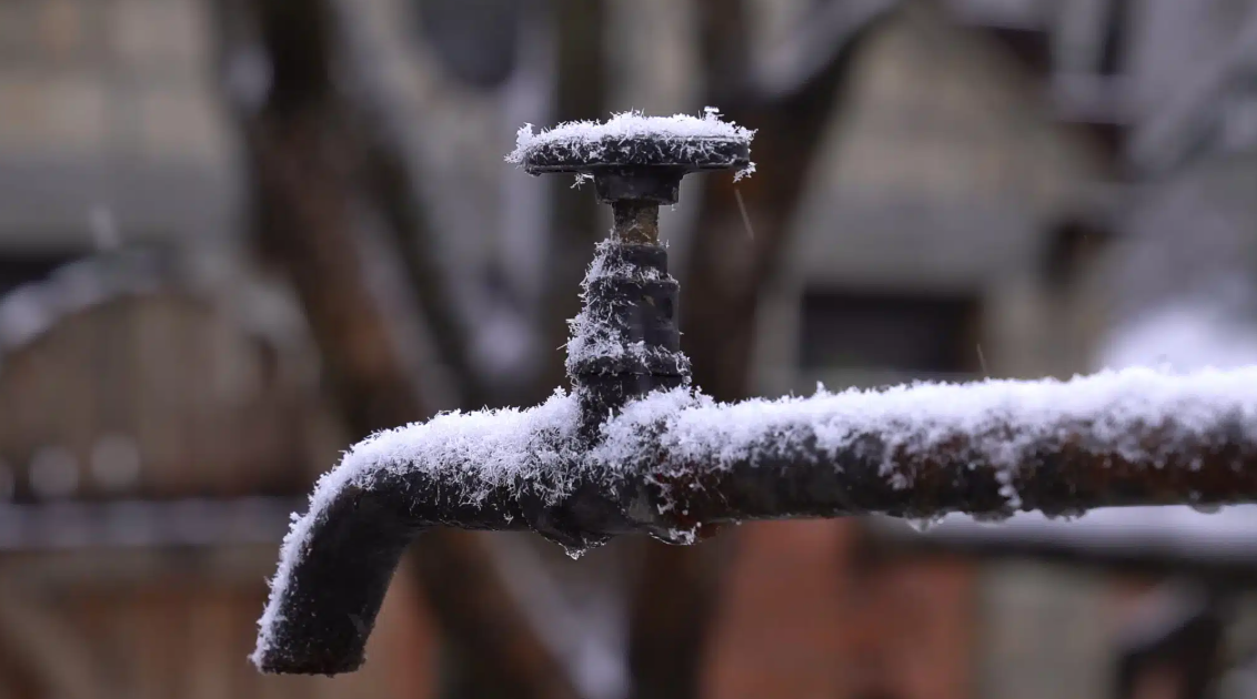 outdoor water spout with snow on it