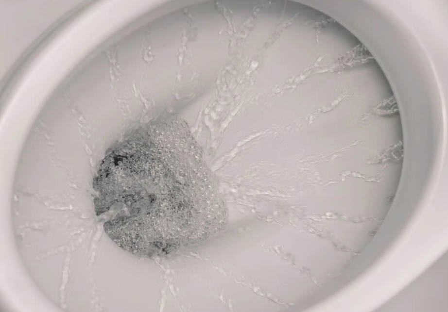 water being flushed down toilet
