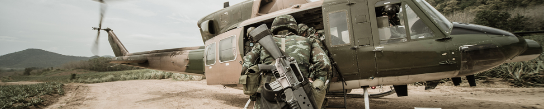military getting into helicopter