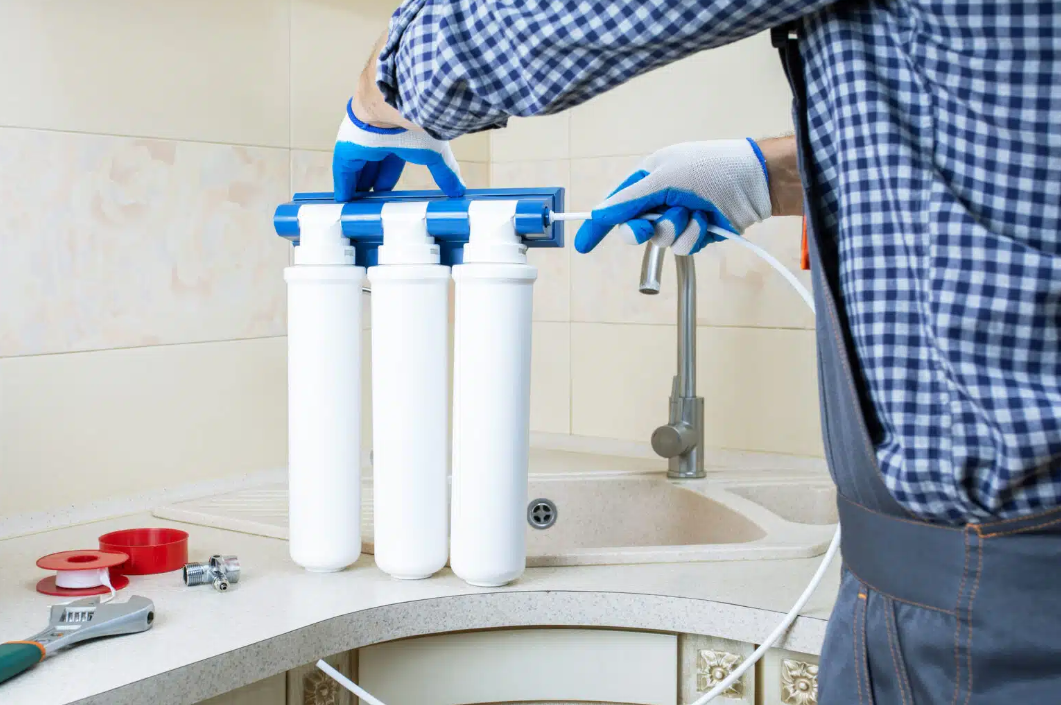 plumber installing water filtration system