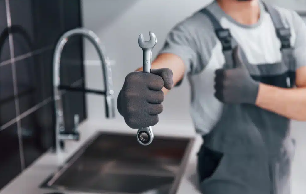 plumber holding out wrench