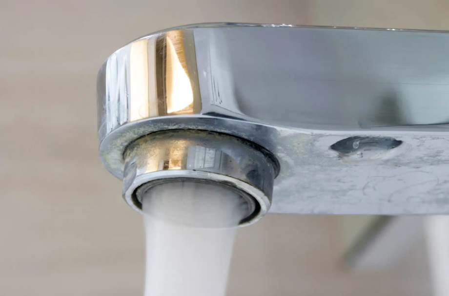 close up of faucet with rushing water