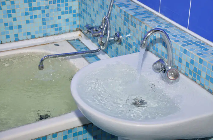 overflowing bathtub and sink
