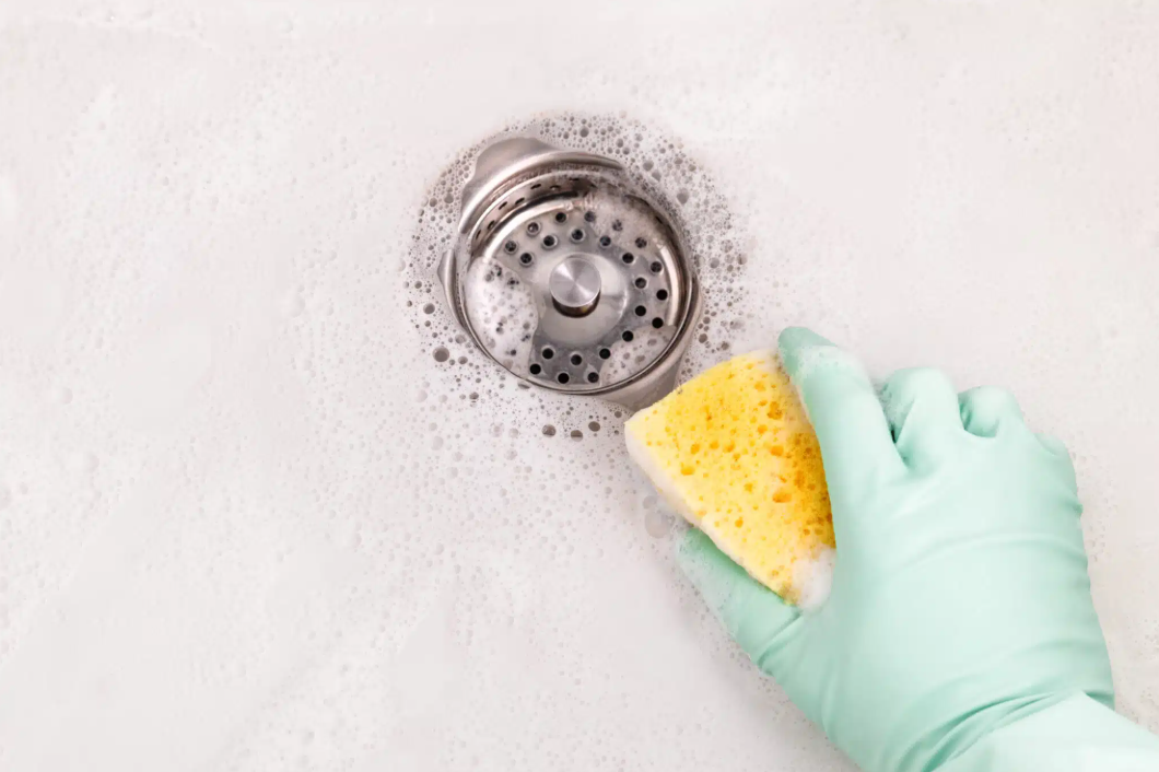 gloved hand scrubbing sink