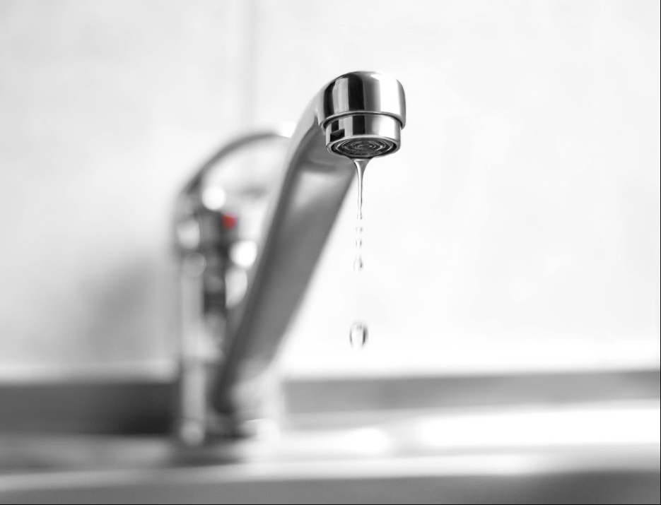 Weak trickle of water coming from a kitchen or bathroom faucet. Simple, clear photo that matches the search intent immediately.