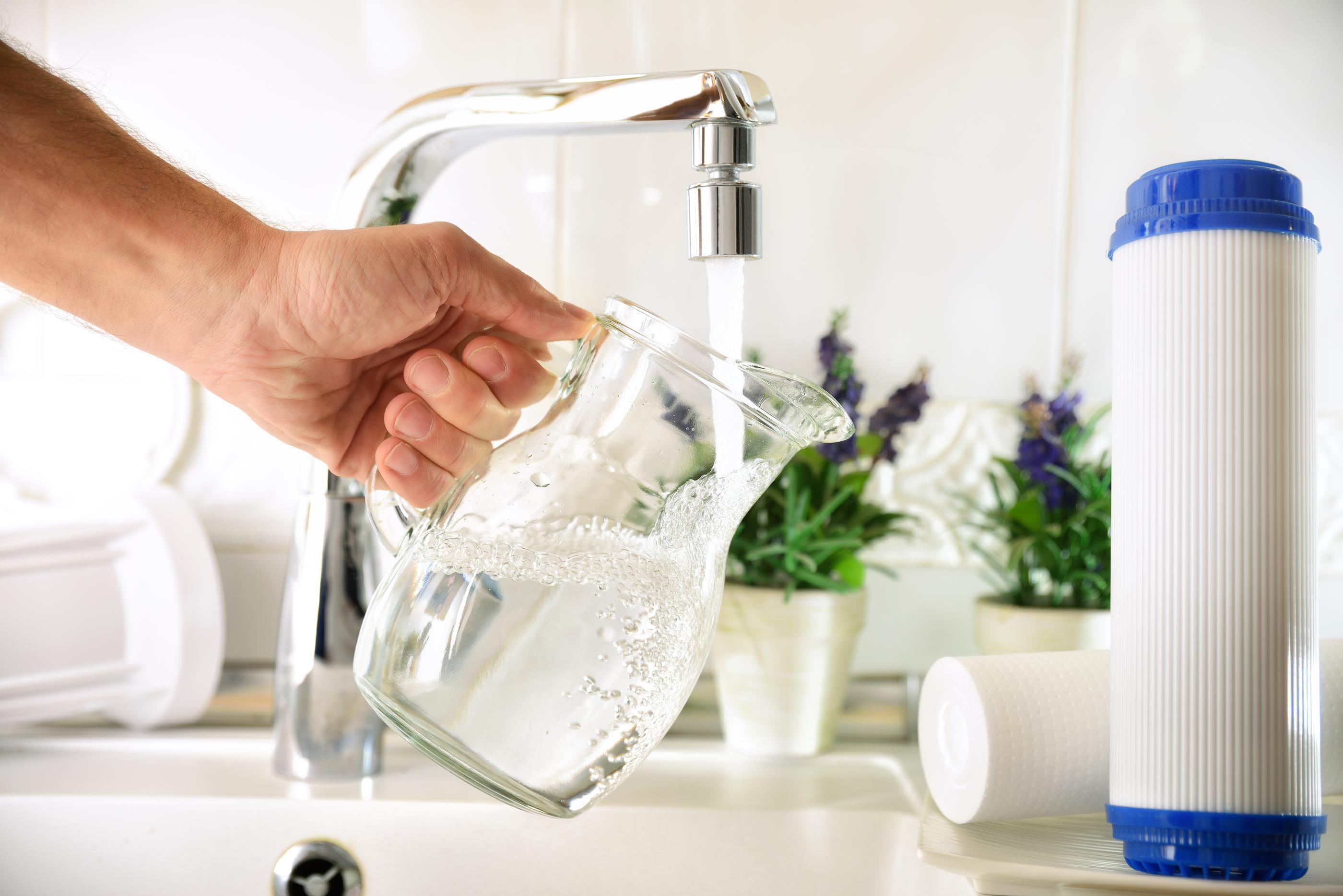 hand filling up water jug