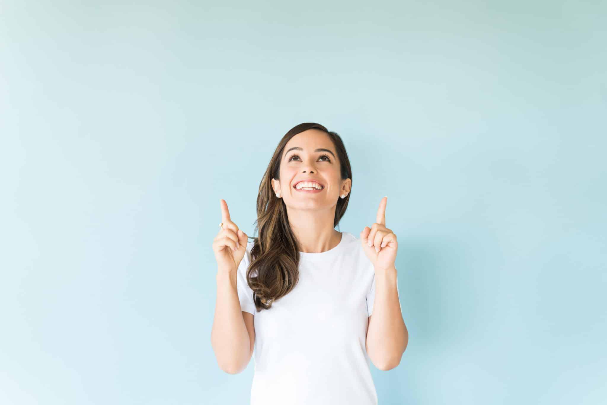 woman smiling and pointing up