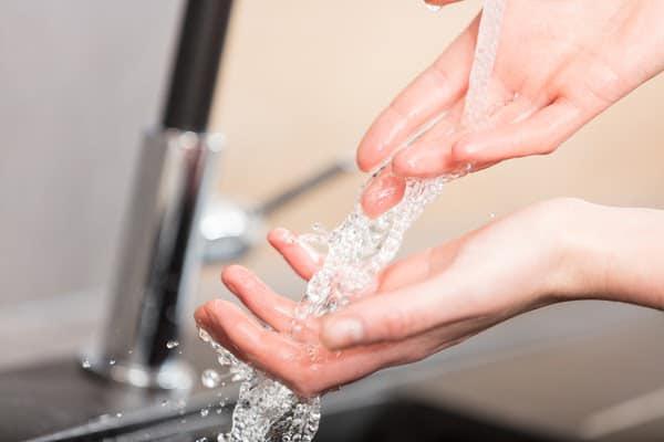 close-up of person washing hands