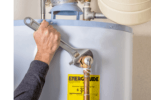 man fixing water heater with wrench