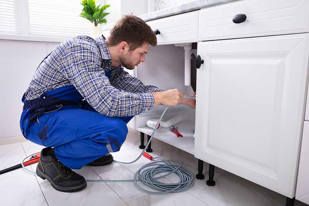 Plumber snaking a drain